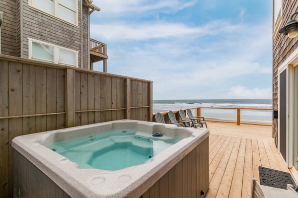 Soak in the hot tub with sweeping ocean views just steps from your door, where waves and sea breezes create the perfect backdrop for relaxation.